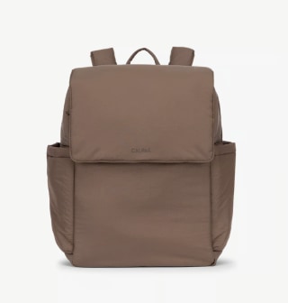 a photo of a dark brown diaper bag from Calpak