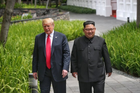 Image: U.S. President Donald Trump walks with North Korean leader Kim Jong Un at the Capella Hotel on Sentosa island in Singapore