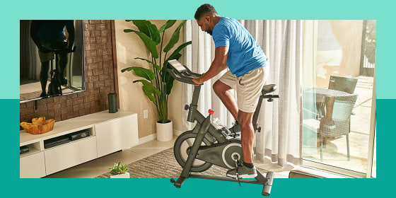 man using exercise bike in living room