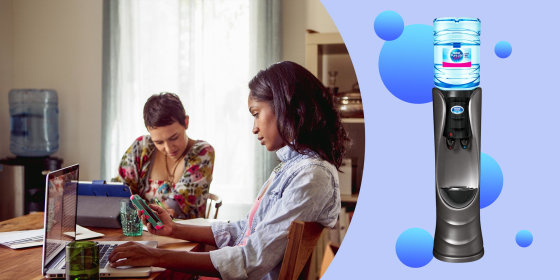 Illustration of two woman working t a table with their water cooler in the background and the Cascade Profile Hot & Cold Water Cooler. How a water cooler improved my work-from-home setup. Learn more about The Cascade Profile Hot & Cold Water Cooler and sh