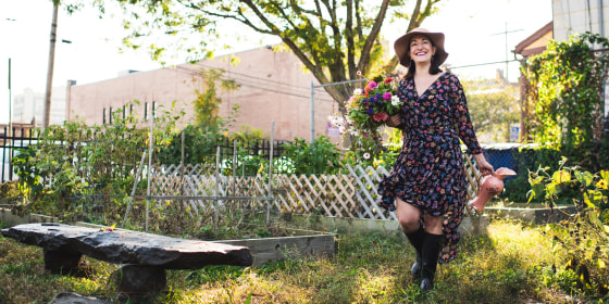 Woman walking through her garden wearing a floral dress, a hat, and holding flowers. The best dress sales and dress deals happening now from Amazon, ASOS, Macy's, Target, Madewell and more can help you find the perfect summer dress.