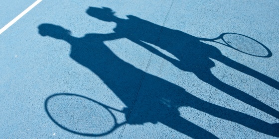 Shadow of tennis players on tennis court