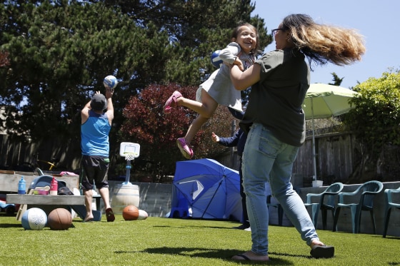 A family celebrates Independence Day during a barbecue in their backyard on July 4, 2020 in San Francisco.