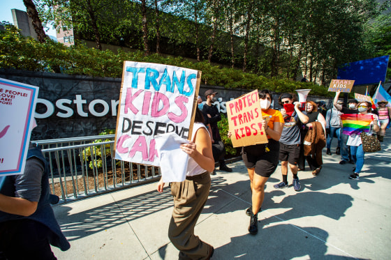 Demonstrators rally at the Boston Children's Hospital to support trans children and gender affirmation treatments.