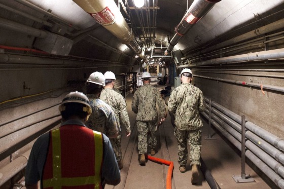 Navy and civilian water quality recovery experts walk through the tunnels of the Red Hill Bulk Fuel Storage Facility, near Pearl Harbor, Hawaii, on Dec. 23, 2021.