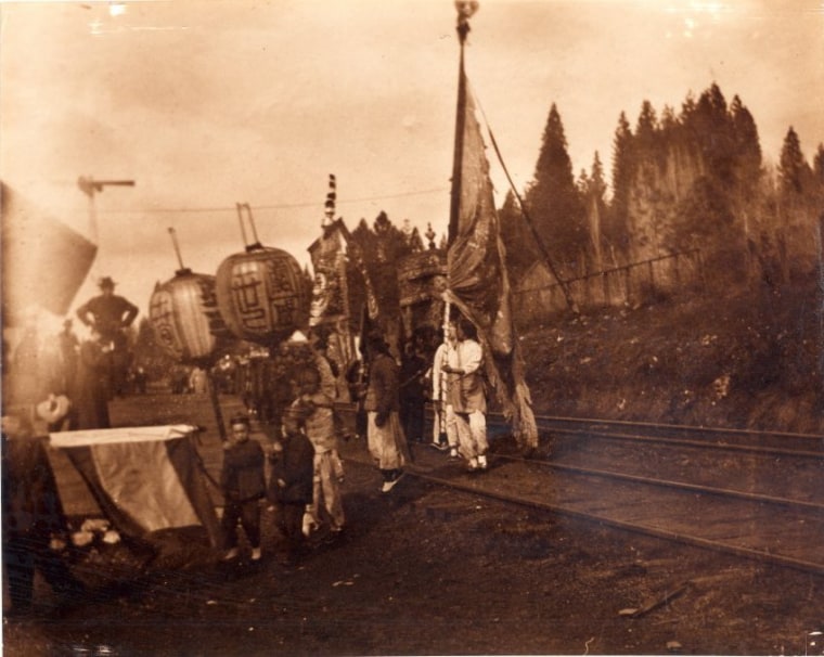 Chinese railroad workers with lanterns and flags at the Dutch Flat Railroad Station area.