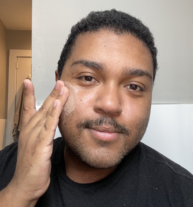 A man applying EltaMD’s Tinted UV Clear Sunscreen to his skin.