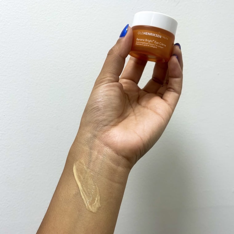 Woman swatching eye cream on her wrist