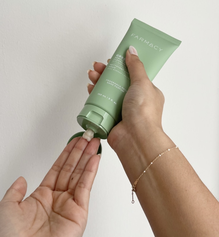 Woman squeezing cream cleanser on her hand