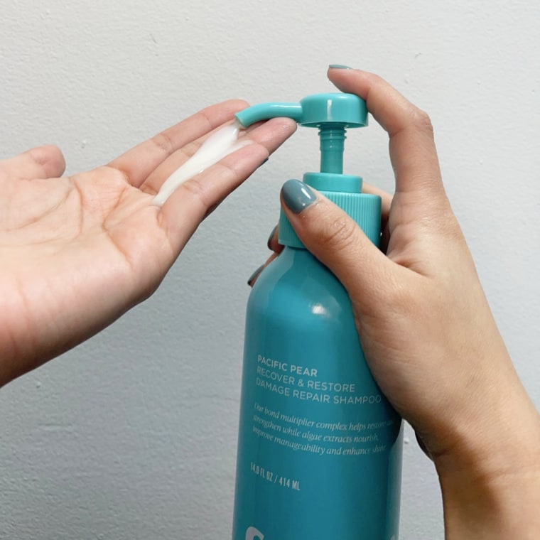 Woman dispenses Saltair Recover & Restore Damage Repair Shampoo into her hand.