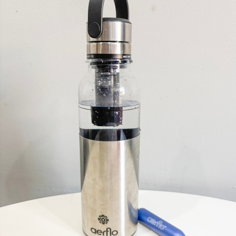 Aerflo Aer 1 bottle sitting on a countertop with a blue capsule beside it.