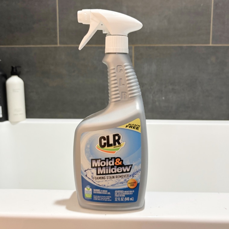 CLR Mold & Mildew Foaming Stain Remover sitting on the side of a tub.