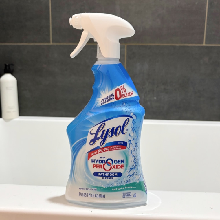 Lysol Hydrogen Peroxide shower cleaner sitting on the side of a bathtub.