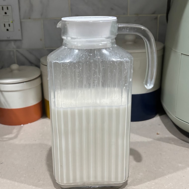 Glass carafe with homemade almond milk in it.
