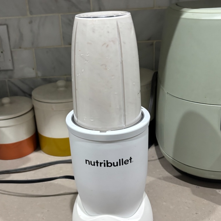 Blended almonds in a Nutribullet Pro personal blender.