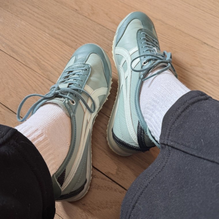 Picture of Onitsuka Mexico 66 sneakers in Ocean Haze color being worn with white socks against wood floor background.
