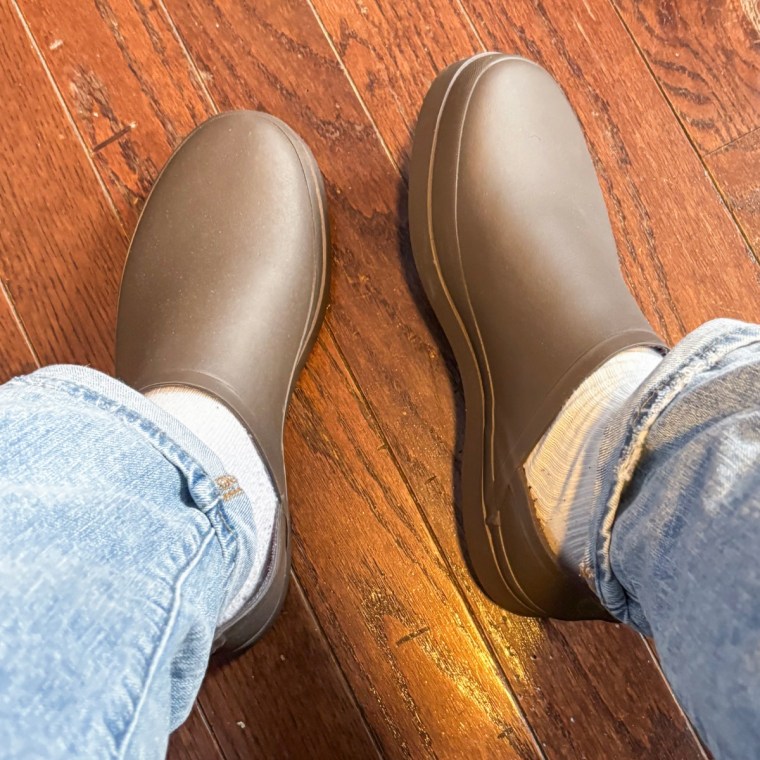 Person wearing the Seavees Calistoga clogs in the color coffee bean with light wash jeans.