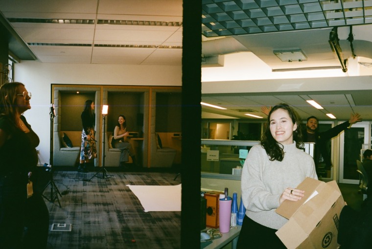 Two photos side-by-side: one of a few women standing in a conference room, another of a woman holding a box smiling at the camera.
