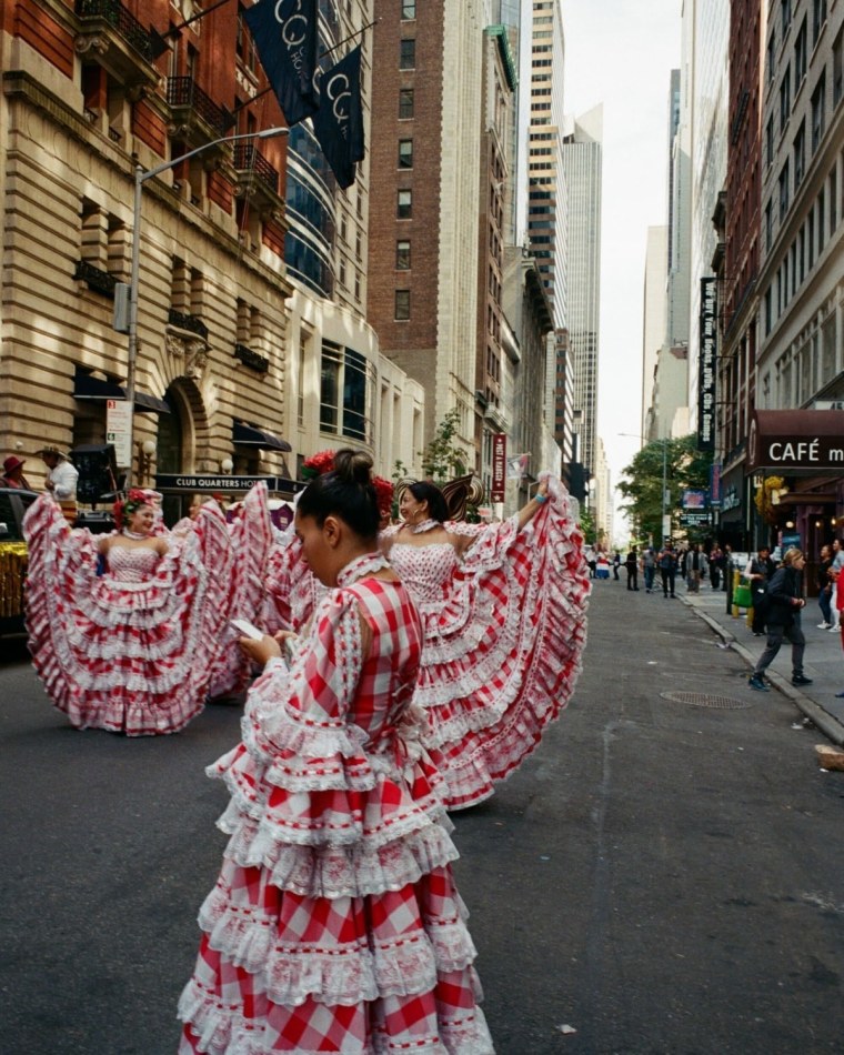 A photo of women wearing red and white dresses practicing for the 60th annual Hispanic Day Parade in New York City.
