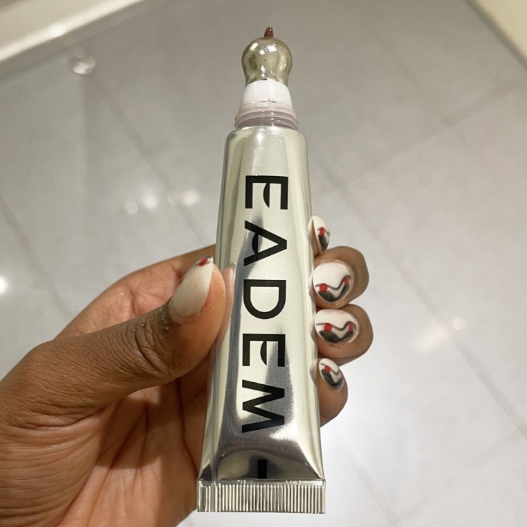 A woman holding the EADEM tube in her hand