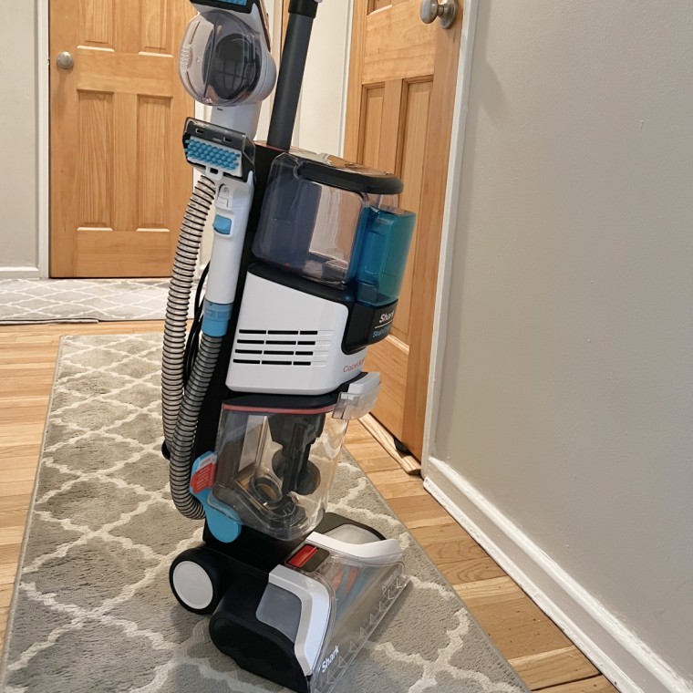 Woman using Shark EX201 Carpet Cleaner on hallway runners
