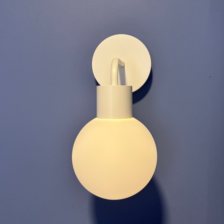 White Poplight attached to wall painted blue.