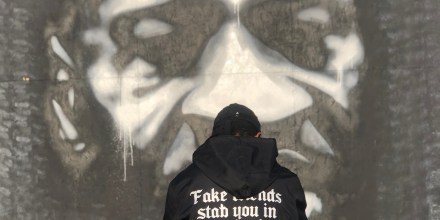 Christopher Martin sits in front of George Floyd's mural in Minneapolis on April 22, 2021.